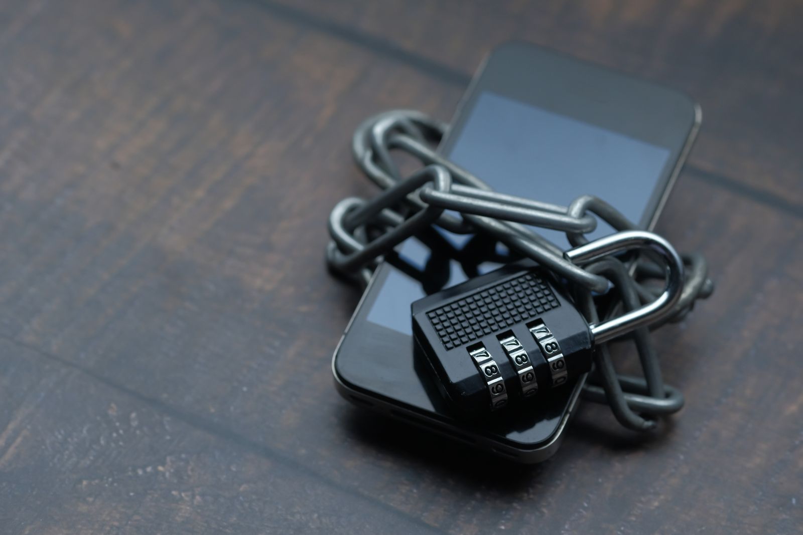 Smartphone secured with chain and padlock